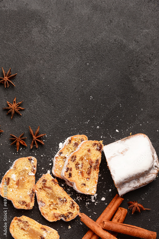 Composition with tasty Christmas stollen on black background