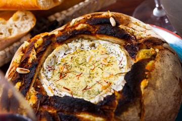 Sticker - Traditional French dish of melted camembert cheese (fondue) in fresh baked bread with dried herbs and pine nuts