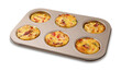Freshly baked bacon and egg muffins with cheese in tin isolated on white