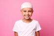 young little girl with cancer without hair smiling on pink background. Cancer day concept