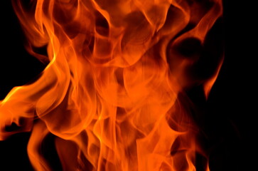Poster - The bright background consists of orange flames and darkness.