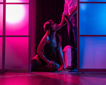 A Woman Is Kneeling In Front Of A Man. BDSM Sex Concept. Vertical Photo. 