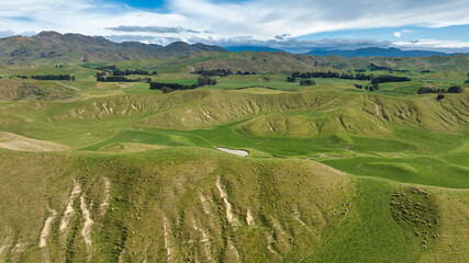 Wall Mural - The rolling green hills and valleys comprising agricultural and farm countryside