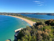 Narrow peninsular is surrounded by water on two sides. Panorama of the ocean. View of the beach and the island's coastline. Palm beach, Australia, NSW. Beach that divides the ocean.