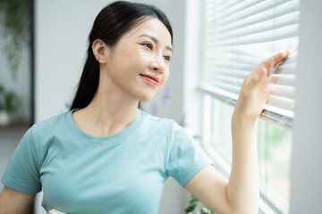 Wall Mural - Photo of young Asian woman at home