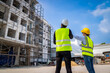 © SKW - Engineer inspect building structure technicians looking at analyzing unfinished construction project