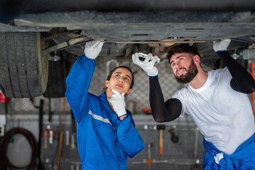 Wall Mural - auto two professional mechanical technician garage motor car engine team check automobile engine for diagnostic maintain transmission machine. technician worker auto in garage check engine car motor