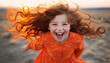 © Keitma - Young girl with auburn hair dressed with an orange color dress stands a top a hill, her face radiating joy and freedom with big smile