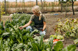 © cherryandbees - Beautiful blond woman working in a garden.