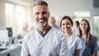 © Kowit - A team of dentists poses in a modern large dental practice.