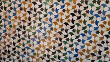 Background Of Old Moorish Mosaic Tiles With Bird And Star Pattern In Alhambra Palace, Granada, Spain