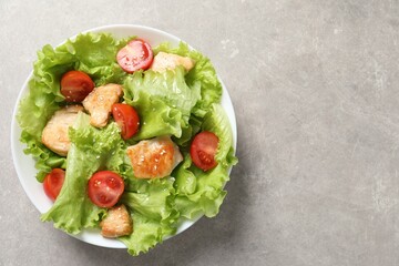 Wall Mural - Delicious salad with chicken and cherry tomato on light grey table, top view. Space for text