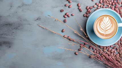 Wall Mural - Light blue cup of cappuccino from above with latte art, dried pink leaves and grasses, on a slate stone, coffee beans, isolated on a white background.