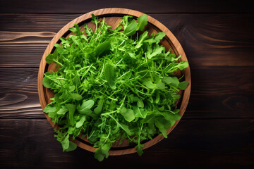 Wall Mural - Fresh arugula leaves on wooden bowl, rucola. Arugula rucola on wooden old background. Arugula rucola for salad. Top view, blank space