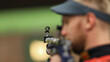 © makedonski2015 - A male athlete shoots with an air rifle. Selective focus on the front sight of the rifle.