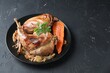 Tasty cooked rabbit meat with vegetables and parsley on black table, space for text