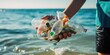 An unrecognizable person holding plastic bottles collected from the sea, symbolizing efforts to address marine pollution and promote environmental conservation