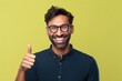 camera looking side finger hand pointing face smile big background isolated glasses wearing man hispanic Adult young boy indian male portrait excited yes success happy joy expression fashion cool