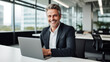 © sema_srinouljan - Company manager, CEO, happy middle-aged company executive working with laptop computer