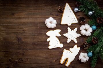 Wall Mural - White Christmas gingerbread cookies with fir tree branches. New Year background