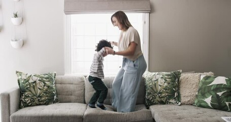 Wall Mural - Family, jump and a mother with her son on a sofa in the living room of their home together for fun. Freedom, energy or love with a woman and boy child playing on a couch in the lounge for bonding