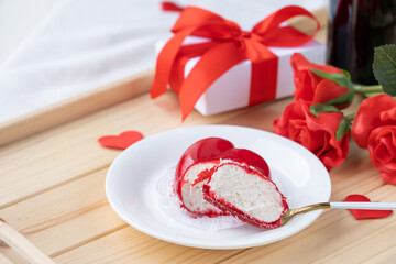 Wall Mural - heart shaped glazed valentine cake and flowers on wooden tray