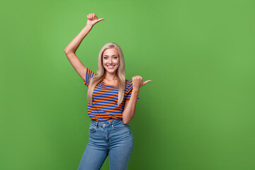 Sticker - Photo advertisement of black friday christmas sale young girl pointing fingers empty space media ad isolated on green color background