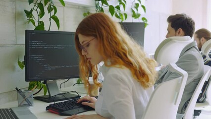 Enthusiastic Female Caucasian IT Programmer Working on Desktop Computer. Lady Specialist Creating Innovative Software. Engineer Developing App, Program, Video Game. Writing Code in Terminal.
