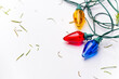 © Andrew Kornylak - Christmas lights and stray pine needles on a white background
