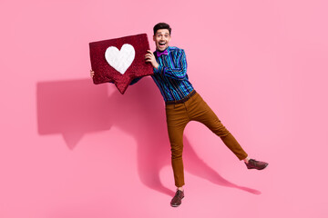 Wall Mural - Full body length photo of young guy demonstrate his handmade heart symbol for girlfriend surprising her isolated on pink color background