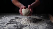 Baker Throwing Dough On The Table With Flour And Flours Fly. Slow Motion