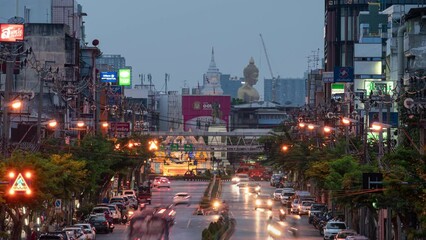 Wall Mural - Cityscape of buildings with traffic on the road and golden large buddha in downtown at night