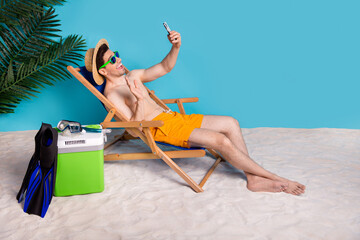 Sticker - Full length photo of positive friendly shirtless man sitting deckchair recording video vlogging empty space isolated blue color background