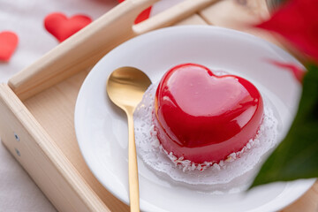 Wall Mural - heart shaped glazed valentine cake in bed on wooden tray