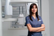 © Guys Who Shoot - portrait of a beautiful young female doctor dentist or radiologist in uniform standing with crossed arms in the beauty and health clinic