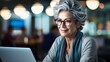 Café Connection: Mature Woman Engaged with Laptop Technology