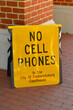 Bright black on yellow sign - NO CELL PHONES in the City of Fredericksburg Courthouse.