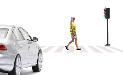 Canvas Print - Woman with a safety vest and books walking in front of a car at pedestrian zebra sign