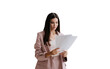 © Iona - Brunette Asian businesswoman in suit holds sheet of papers looks at documents stands against transparent background. Successful lawyer explores issue at office. Financial bill.