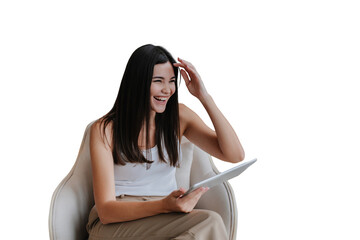 Laughing asian girl with long loose hair sitting in chair with laptop against transparent background tablet loud smiling during video call. Beautiful Korean model relaxing home on weekend.