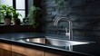 Modern kitchen sink with faucet on black countertop in modern kitchen with a window