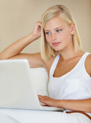 Poster - Young woman, laptop and relax on sofa with online streaming service for website, movie or social media. Person watch or reading on her computer for internet search and subscription on a couch at home