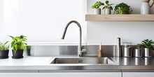 Modern Kitchen With Stainless Steel Faucet, Island Sink, And Wall-mounted Kitchenware.