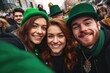 Group of young people perform St. Patrick day. Youth celebrating Saint Patrick's day posing outside on street make selfie posing, Wear green clothes, laughing, going to pub drink beer