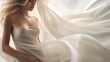 © Olga - a beautiful blonde woman in a white dress with a flowing white fabric over her shoulder and her hair blowing in the wind, in front of a white background is a flowing fabric.