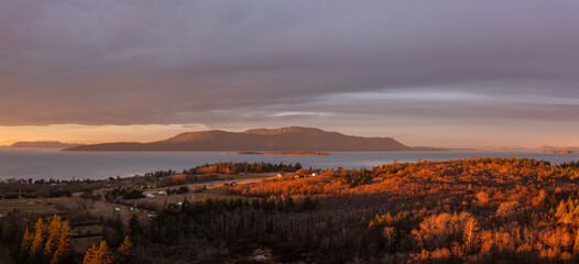 Wall Mural - Aerial View of Sunrise Over Orcas Island, Washington. Located in the Salish Sea, Orcas Island is seen from Lummi Island across the Rosario Strait in the San Juan Island archipelago.