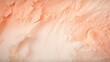 A captivating closeup of a Peach Fuzz colour backdrop with a delicate, powdery surface and a gentle blend of peach and cream hues.