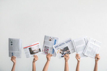 Canvas Print - Female hands with different newspapers against light background