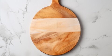 Wall Mural - Top view of a round wooden serving board with handle on a marble table. Kitchenware, template with copy space. Flat lay design, mockup. Cooking concept.