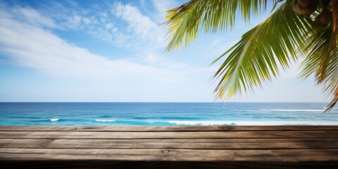 Poster - Ideal holiday scenery with a vacant wooden table, summer ocean waves, palm leaves, and a cloudy blue sky.